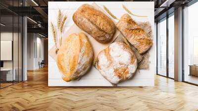 Homemade natural breads. Different kinds of fresh bread as background, top view with copy space Wall mural