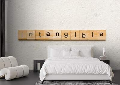 intangible word written on wood block. intangible text on cement table for your desing, concept Wall mural