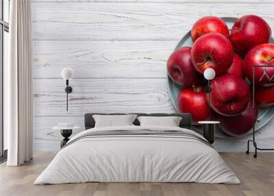 juicy red apples in a bowl or plate on the table top view. Copy space Wall mural