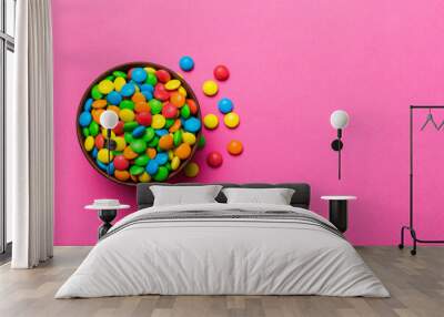 Multicolored candies in a bowl on a colored background. birthday and holiday concept. Top view with copy space Wall mural