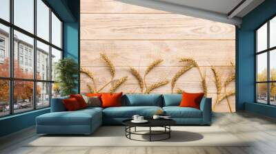 Sheaf of wheat ears close up and seeds on colored background. Natural cereal plant, harvest time concept. Top view, flat lay with copy space. world wheat crisis Wall mural