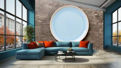 Top view of empty blue plate on cement background. Empty space for your design Wall mural