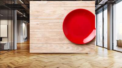 Top view of empty red plate on wooden background. Empty space for your design Wall mural