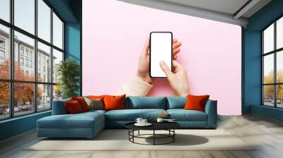 Top view of woman hands holding smart phone with blank copy space screen for your text message or information content. woman hand using phone white screen on top view Wall mural