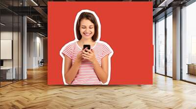 young woman in a red striped t-shirt looks at the phone and smiles, good news, joy. emotional girl Magazine collage style with trendy color background Wall mural