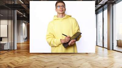 A male designer in yellow hoody holding graphic tablet Wall mural