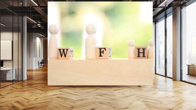 Work from home or initial is  W F H  word on wooden block on blue cloth with green light bokeh background as new normal because of COVID-19 virus. Wall mural