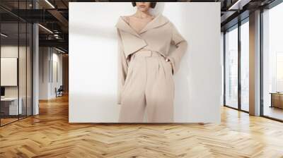 Beautiful brunette with graphic bob haircut wear beige fashion pantsuit Wall mural