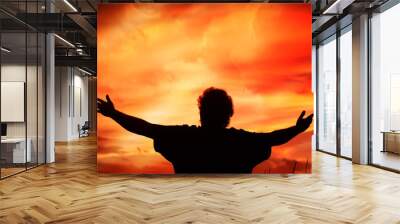 man holding arms up in praise Wall mural