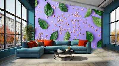 Seeds and green leaves on purple background, flat lay top view pattern  Wall mural