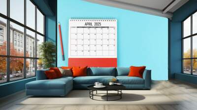 April desk calendar for 2025 year with pencil on blue background, Position with copy space. Wall mural