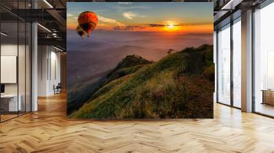 Hot air balloons floating up to the sky over mountain landscape Wall mural