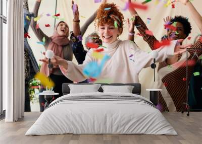 Action shot of young white woman celebrating International Women's Day with friends and ticker tape Wall mural