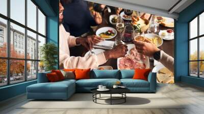 Friends toasting at dinner in restaurant Wall mural