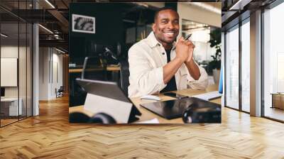 Young Black Male Advertising Marketing Or Design Creative In Modern Office Sitting At Desk Working On Computer Smiling to Camera Wall mural