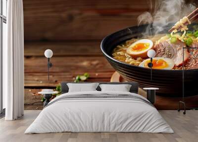 Chopsticks with a Ramen Bowl: A copy space image featuring chopsticks placed on a wooden table next to a steaming bowl of ramen Wall mural