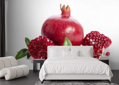 one whole and part of a pomegranate with pomegranate seeds and leaves isolated on white background Wall mural