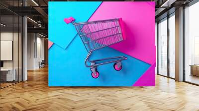 A shopping cart is on a colorful background Wall mural