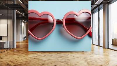 A pair of red sunglasses with a heart shape on the lens Wall mural