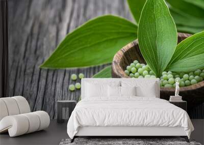 A bowl of green pills is on a wooden table Wall mural