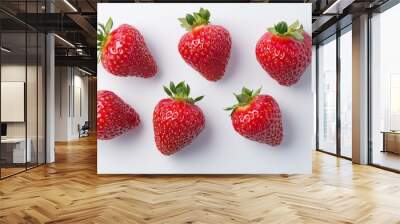 A close up of six red strawberries on a white background Wall mural