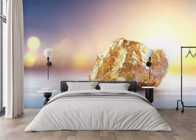 A large gold rock sits on a table Wall mural