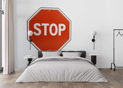 A person holding a red stop sign against a plain background in a clear and concise manner Wall mural