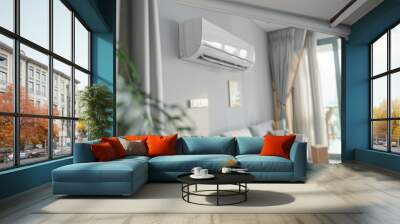 A white air conditioner is mounted on the wall above a couch. Summer heat concept Wall mural