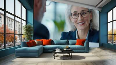 a woman with glasses and a man in a suit Wall mural