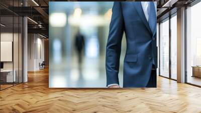 Professional Businessman in Suit Walking Through Modern Office Environment with Blurred Background Wall mural