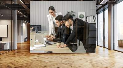 Financial advisors collaborate to assess a company's financial performance using data from its operational activities. Team members work together in a discussions meeting to develop a business plan. Wall mural