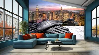 A pair of black leather gloves resting against a marble surface with a stunning cityscape backdrop. 2 Wall mural