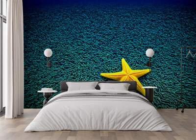 Minimalist photo of a yellow starfish on a blue background. 2 Wall mural