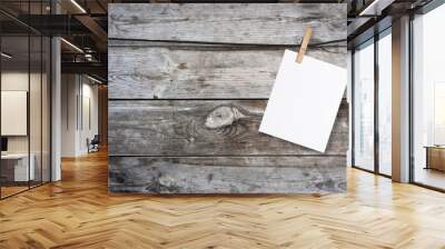 clothespin hanging with blank paper on wooden background
 Wall mural