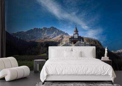 Memorial Church of the Holy Spirit in Javorca in Slovenia built by Austro-Hungarian soldiers. Famous picturesque stairs, Alps mountain range and blue sky in background. Low angle, wide shot Wall mural