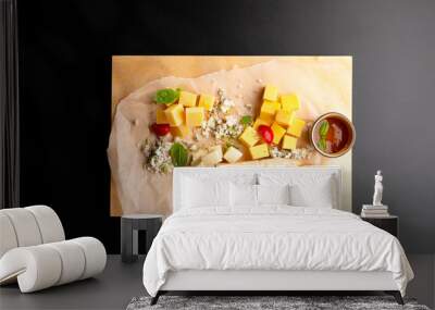 Cheese plate with four types of cheese, served with bread toast and sauce. Wall mural