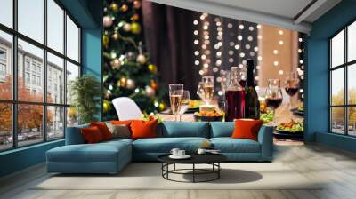 Festive table setting. Food and drinks, plates and glasses. Evening lights and candles. New Year's Eve. Wall mural