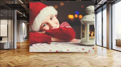 Christmas child writing letter to Santa in red hat Wall mural