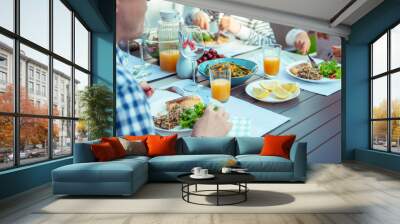 Happy family eating healthy dinner on terrace at home Wall mural