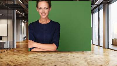 Happy cheerful young woman looking at camera Wall mural