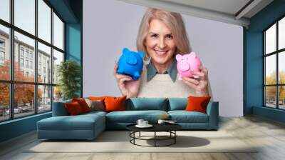 old woman holding two piggy banks Wall mural