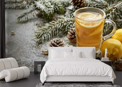 Refreshing Glass of Tea with Lemon on Rustic Background with Fir Branches and Cones - Organic Beverage Concept Wall mural