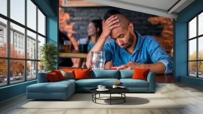 A lonely man sitting at the bar Wall mural