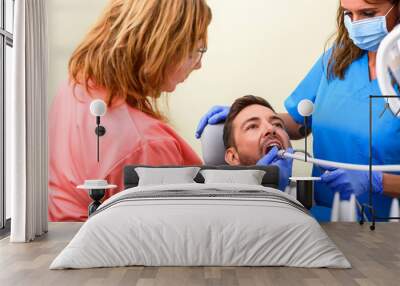 A patient getting treatment in a dental studio	 Wall mural