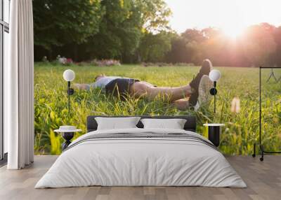 A young man lying in the Grass	 Wall mural