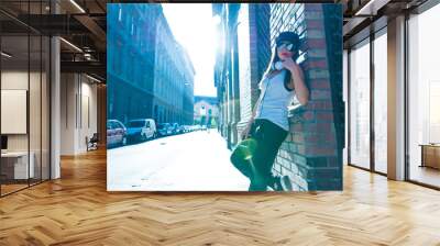 hip hop girl with headphones in a urban environment Wall mural