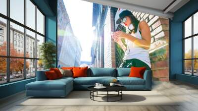 hip hop girl with headphones in a urban environment Wall mural