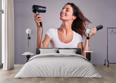 Young woman with hairdryer  Wall mural