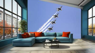 Four US Air Force F-16C Fighting Falcons, known as the Thunderbirds, flying in formation with white trailer of smoke over the 42nd Naval Base Ventura County (NBVC) Air Show at Point Mugu, Ventura County, Southern California. Wall mural