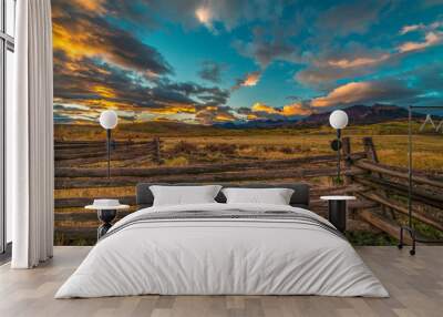 OCTOBER 3, 2018, RIDGWAY COLORADO USA - Sunrise on worm western fence in front of San Juan Mountains in Old West of Southwest Colorado near Ridgway Wall mural